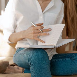 Woman holding notebook and pen