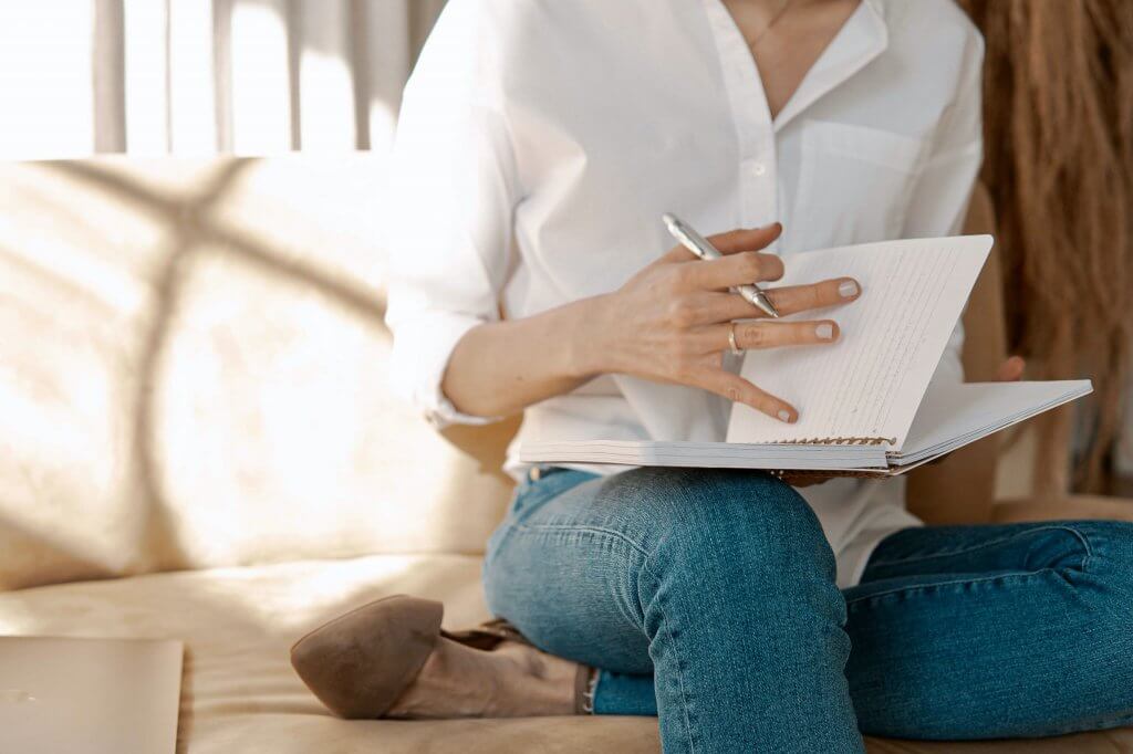 Lady writing in a book.